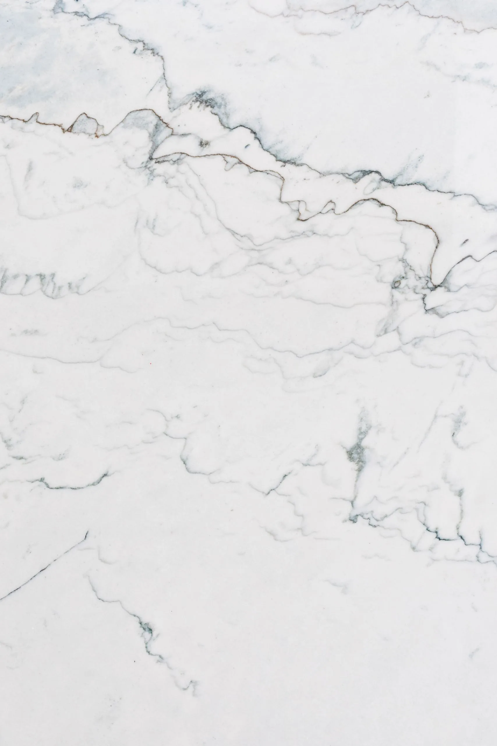 High-resolution white marble texture with natural patterns, perfect for backgrounds.